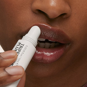 Model applying Tripeptide Berry Lip Balm